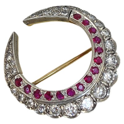 Lot 7 - A Diamond and Ruby Double Crescent Brooch, circa 1950.